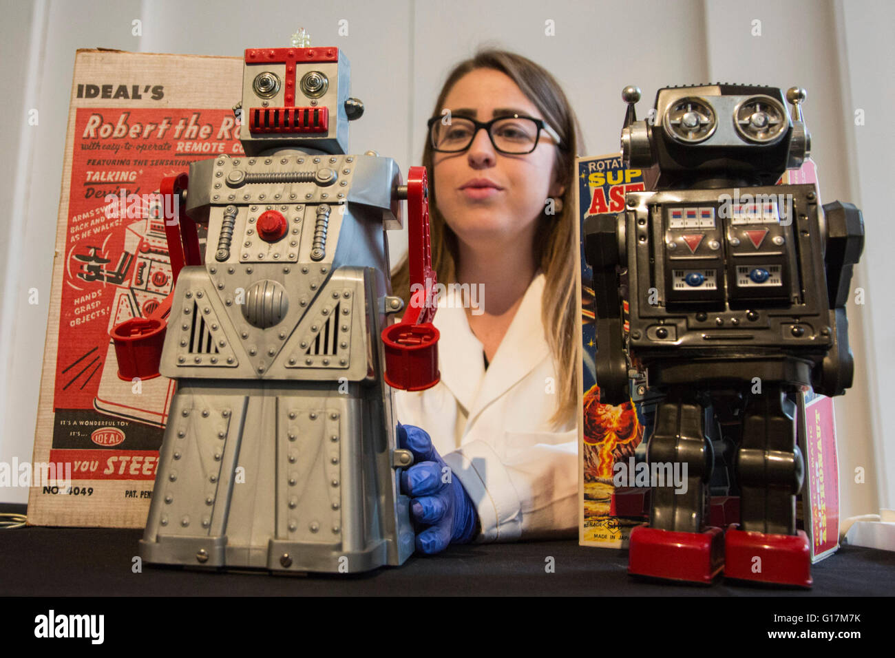 London, UK. 10 May 2016. Pictured: conservator Vanessa Applebaum handles toy robots Robert the Robot and the Super Astronaut Robot. The London Science Museum announces Rise of the Robots, the remarkable 500-year history of robots, in a new exhibition starting February 2017. Over 100 robots will feature in the exhibition which makes it the most significant collection of humanoid robots ever displayed in the world. Stock Photo