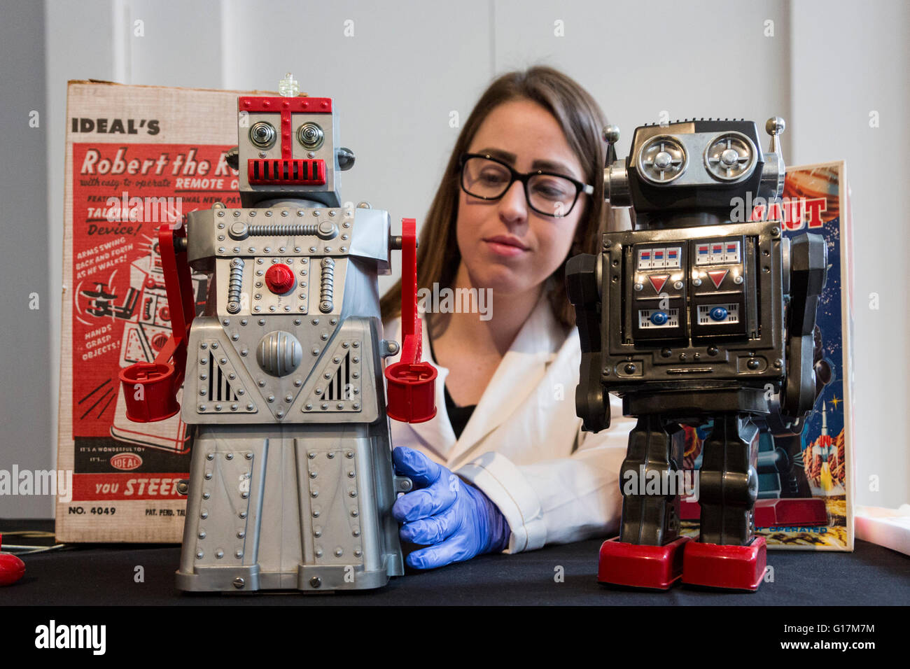 London, UK. 10 May 2016. Pictured: conservator Vanessa Applebaum handles toy robots Robert the Robot and the Super Astronaut Robot. The London Science Museum announces Rise of the Robots, the remarkable 500-year history of robots, in a new exhibition starting February 2017. Over 100 robots will feature in the exhibition which makes it the most significant collection of humanoid robots ever displayed in the world. Stock Photo