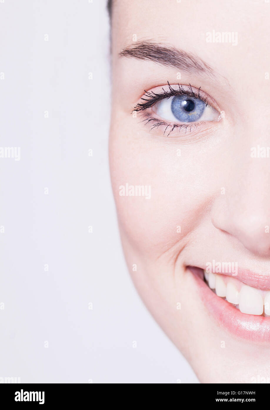 Cropped close up portrait of beautiful young woman with blue eyes Stock Photo