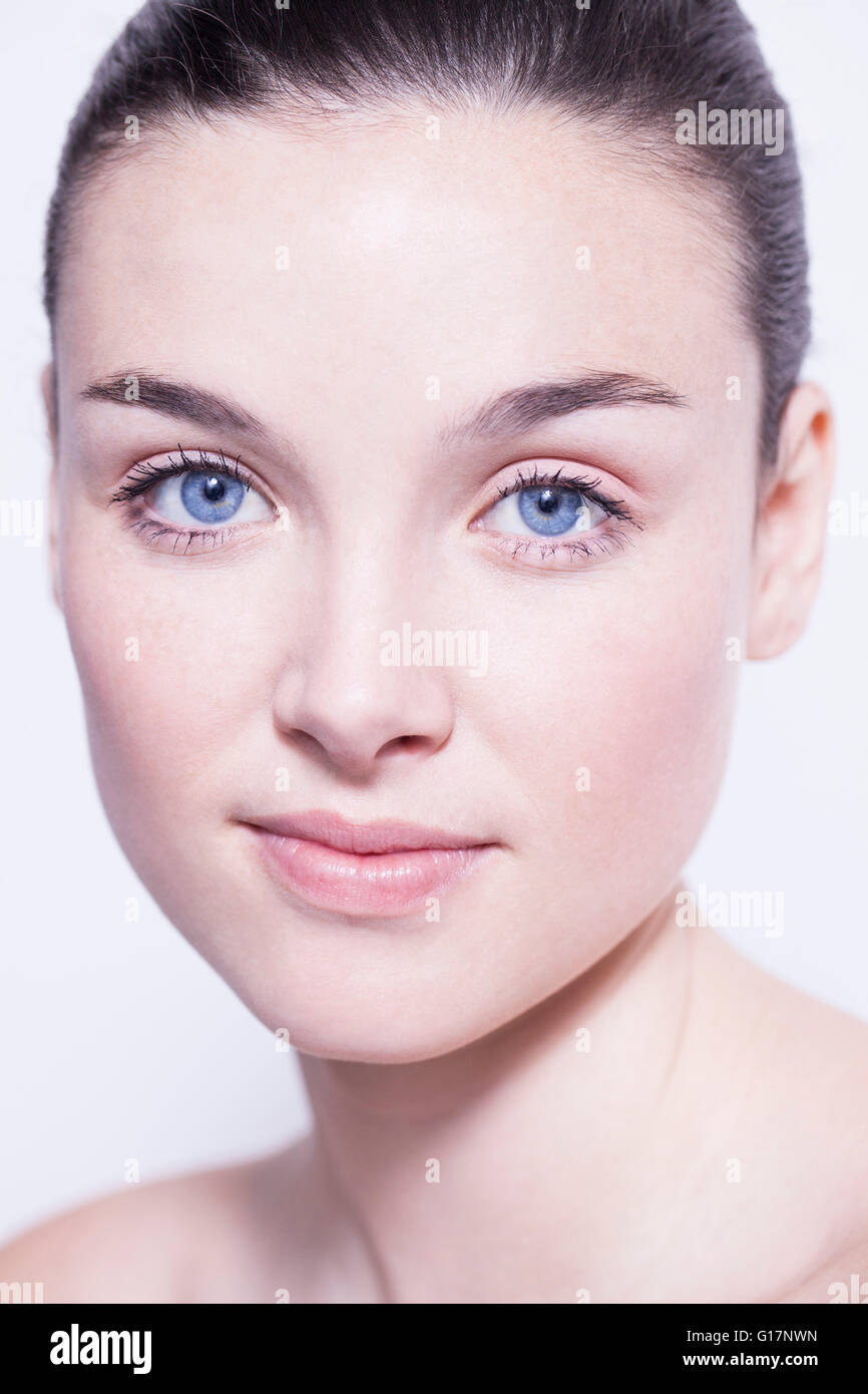 Head and shoulder shot of beautiful young woman with blue eyes Stock Photo