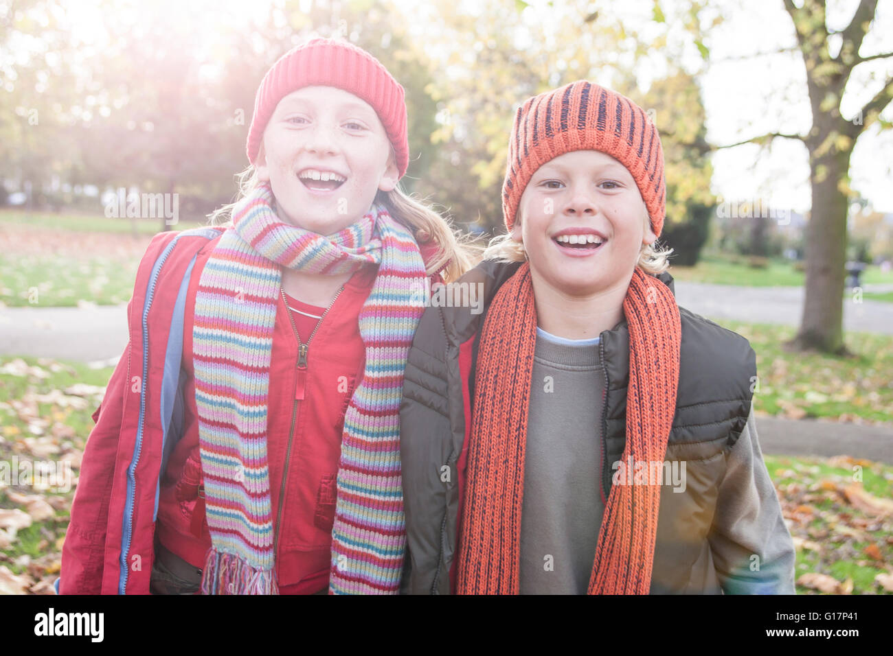 Portrait of brother and sister in park, smiling Stock Photo - Alamy