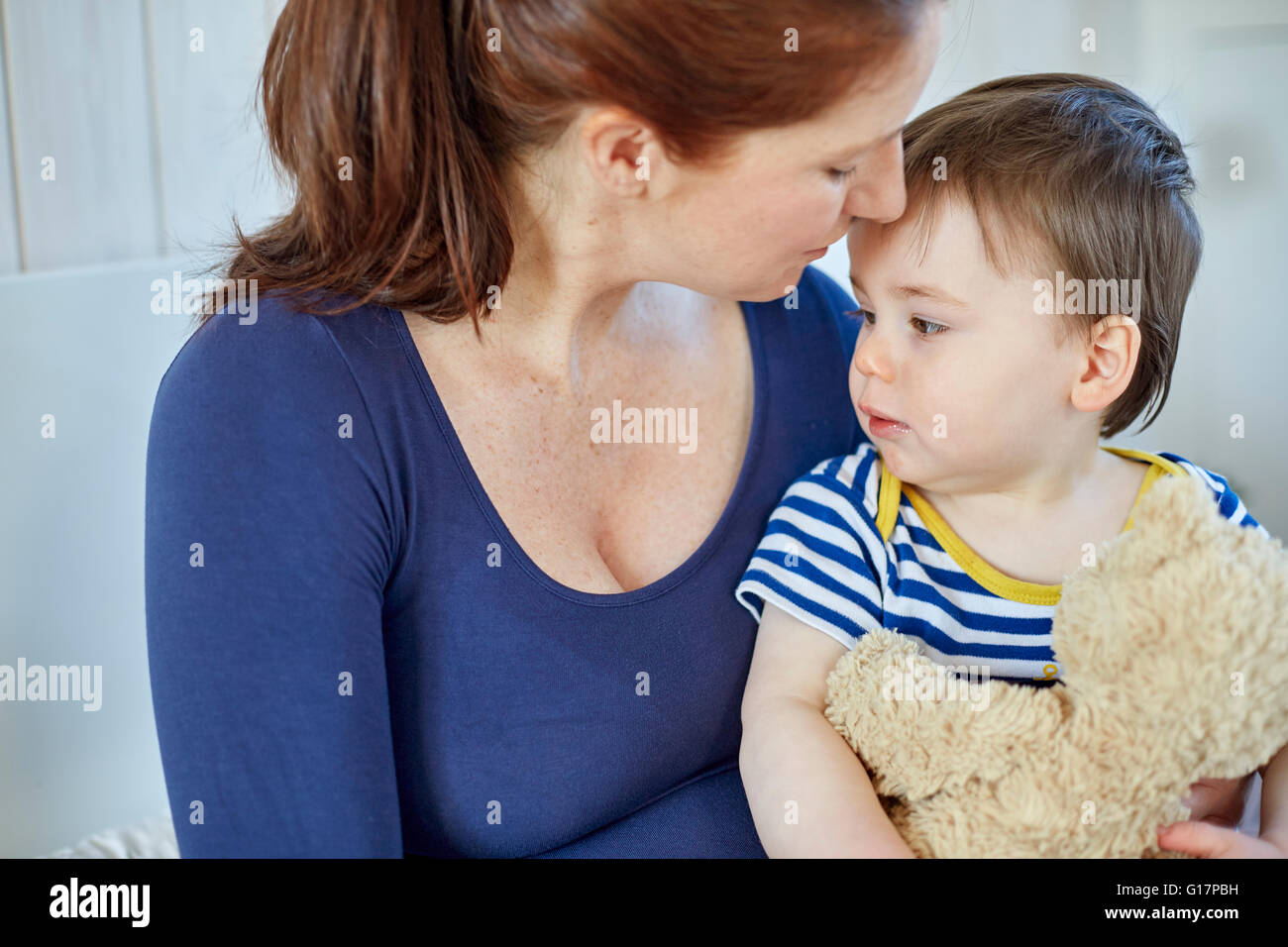 Mother and baby boy holding teddy bear Stock Photo