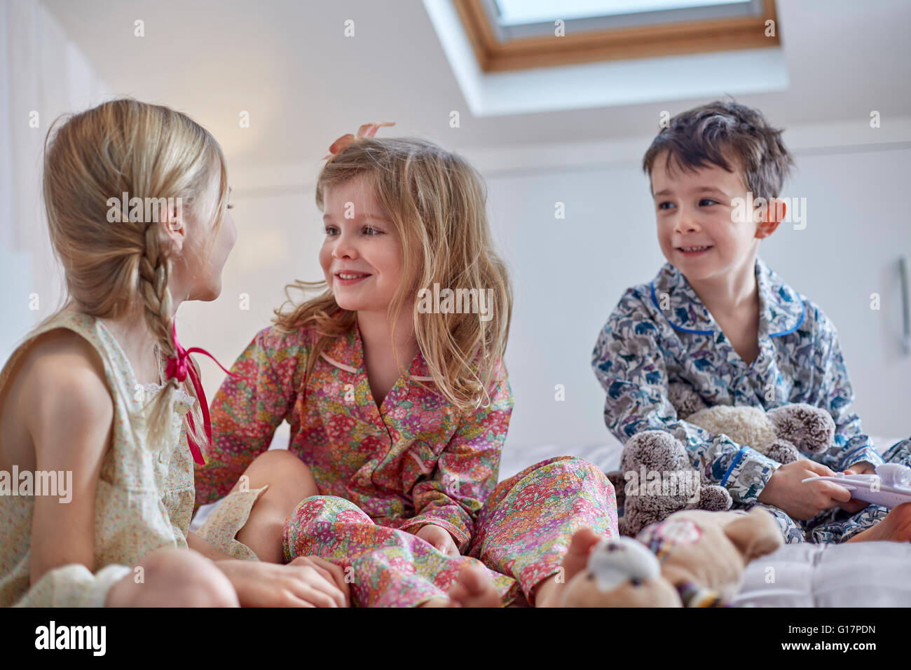 Children chatting in loft room Stock Photo