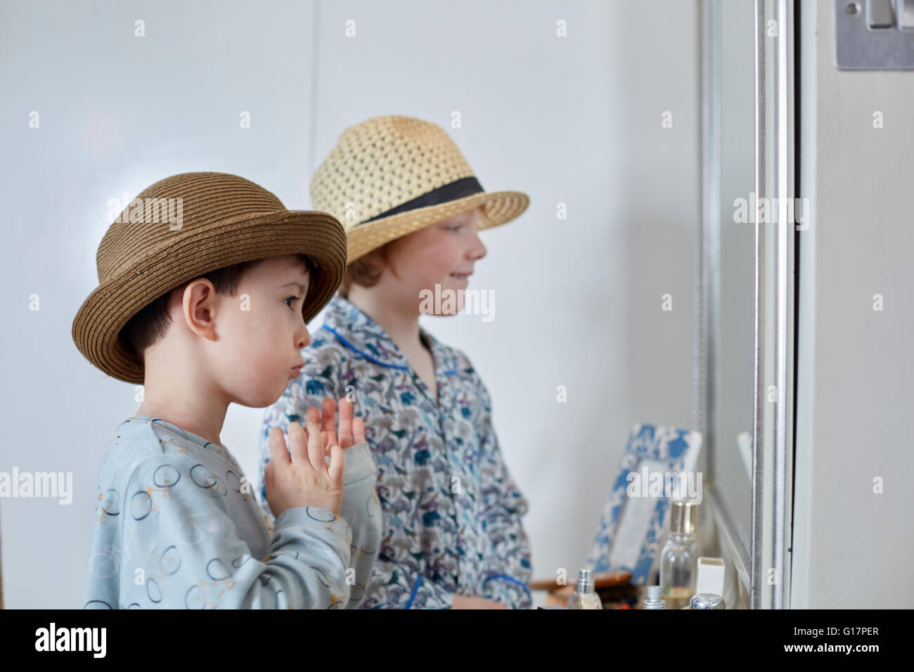 Boys playing dress-up in bedroom Stock Photo