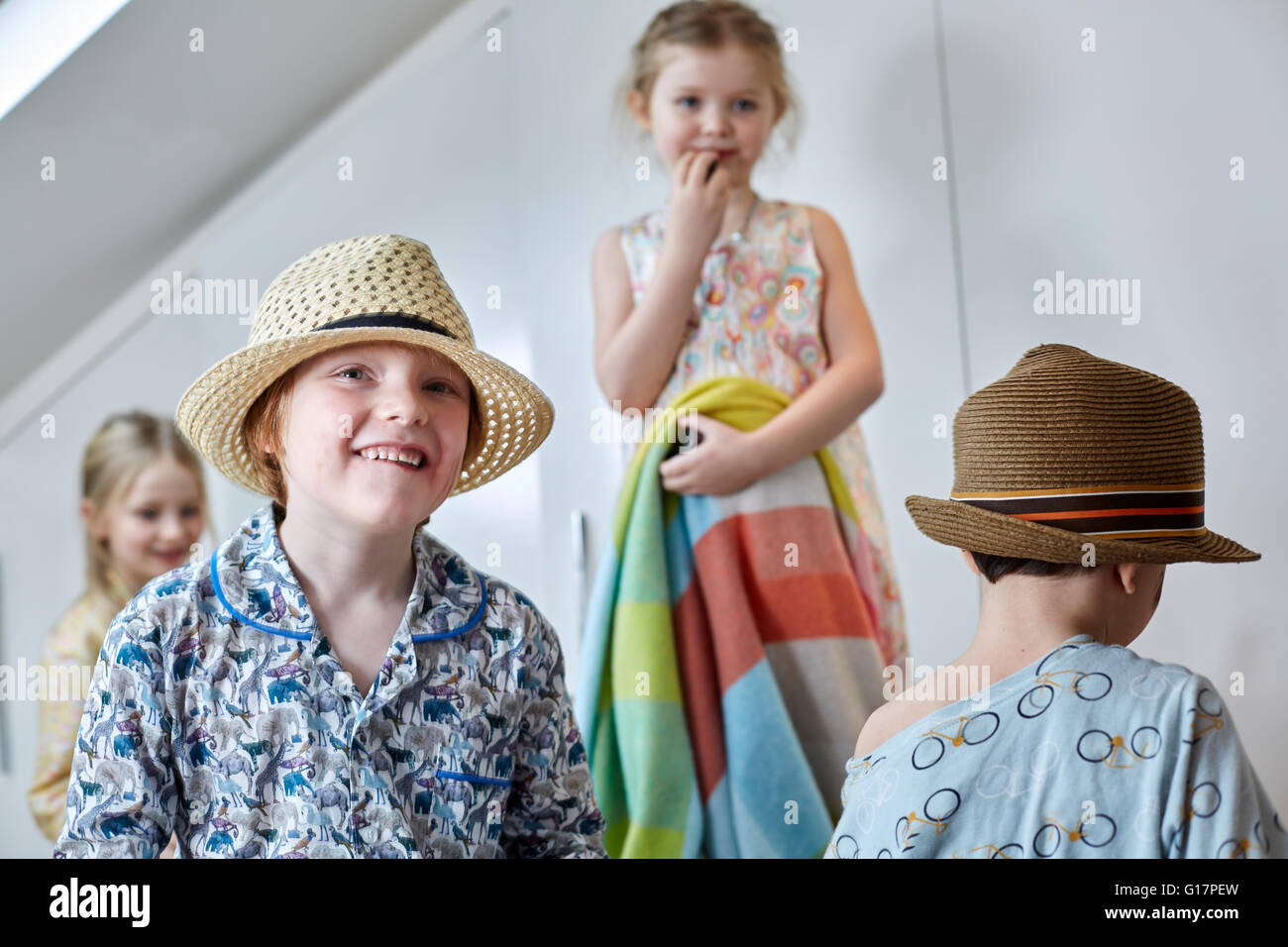 Children playing dress-up in loft room Stock Photo