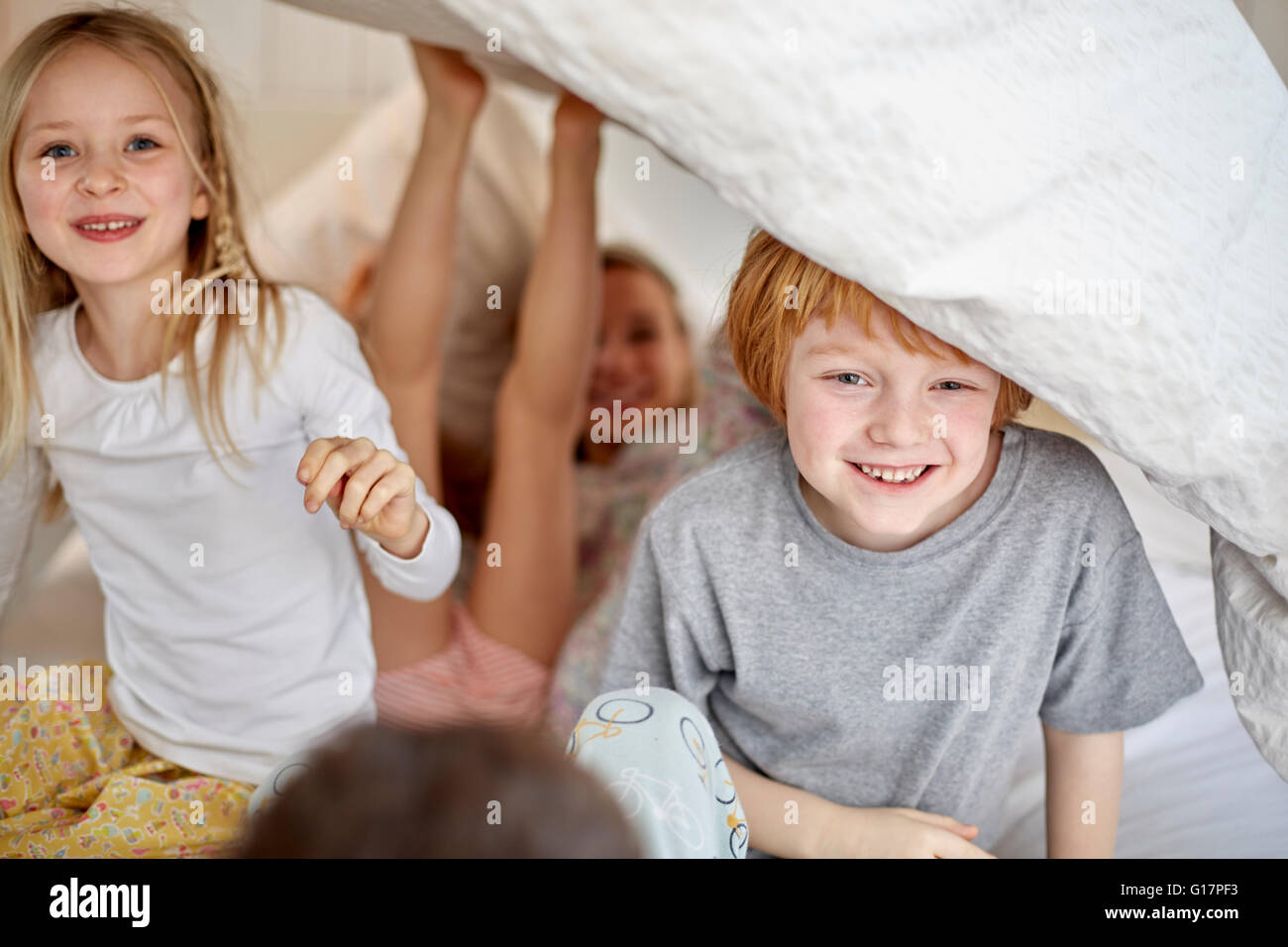 Children having fun playing in bed Stock Photo