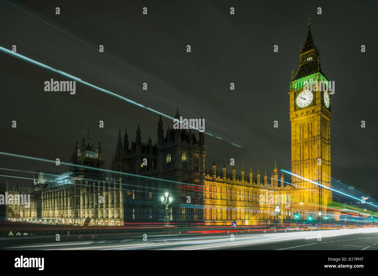 Traffic light trails passing Westminster Palace and Big Ben at night, London, UK Stock Photo