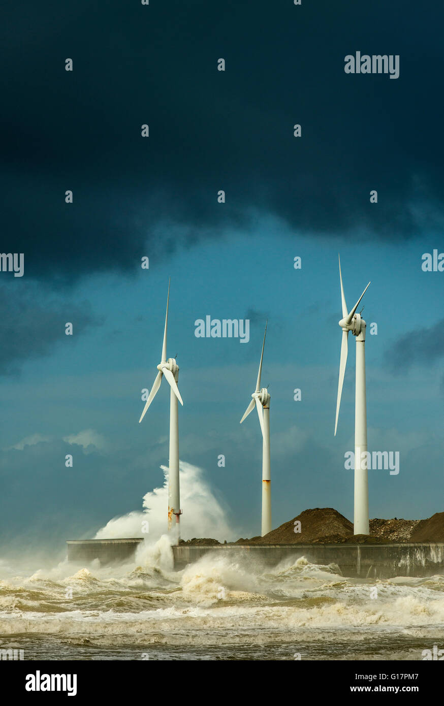 Three wind turbines amidst fierce storm waves at coast, Boulogne-sur-Mer, Nord-pas-de-Calais, France Stock Photo