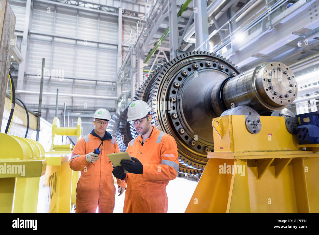 Workers with gas turbine in gas-fired power station Stock Photo