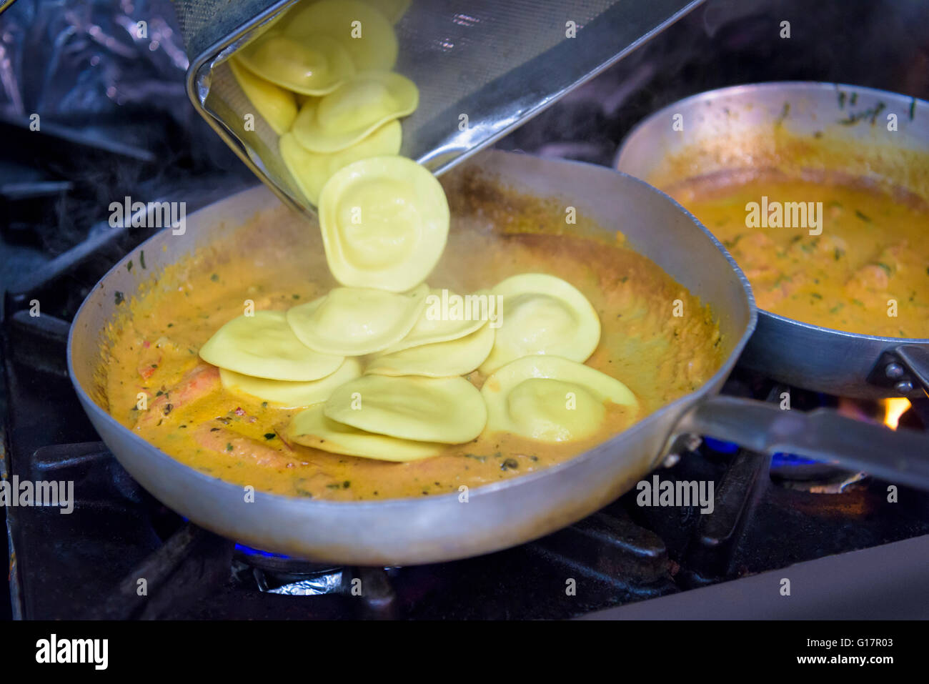 Ravioli cooking in pan in traditional Italian restaurant kitchen Stock Photo