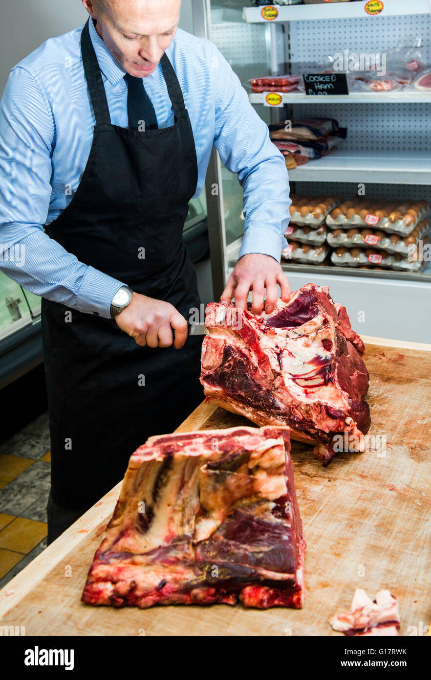 Butcher preparing beef joint Stock Photo