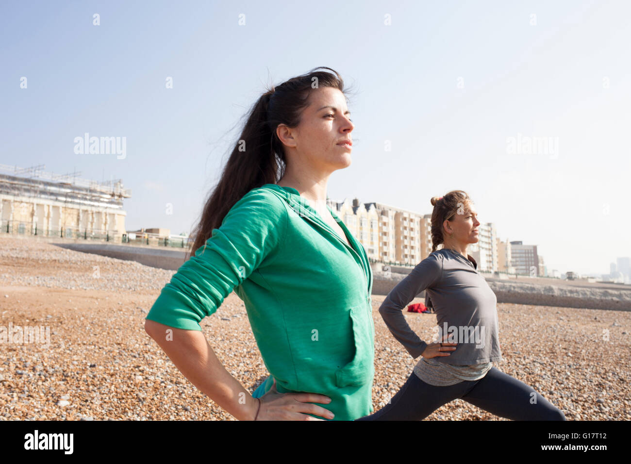 Two women doing warm up training on Brighton beach Stock Photo