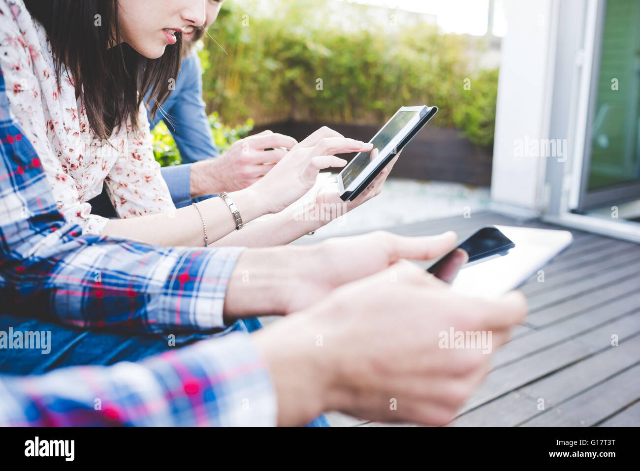 Cropped shot of designers using digital tablets on office roof terrace Stock Photo