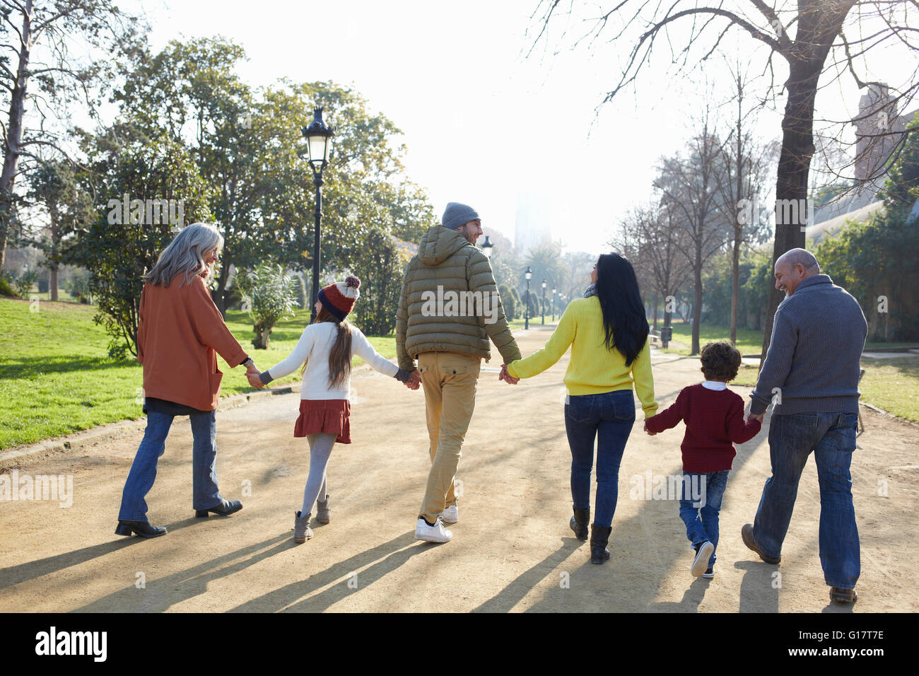 Rear view of multi generation family walking in park Stock Photo