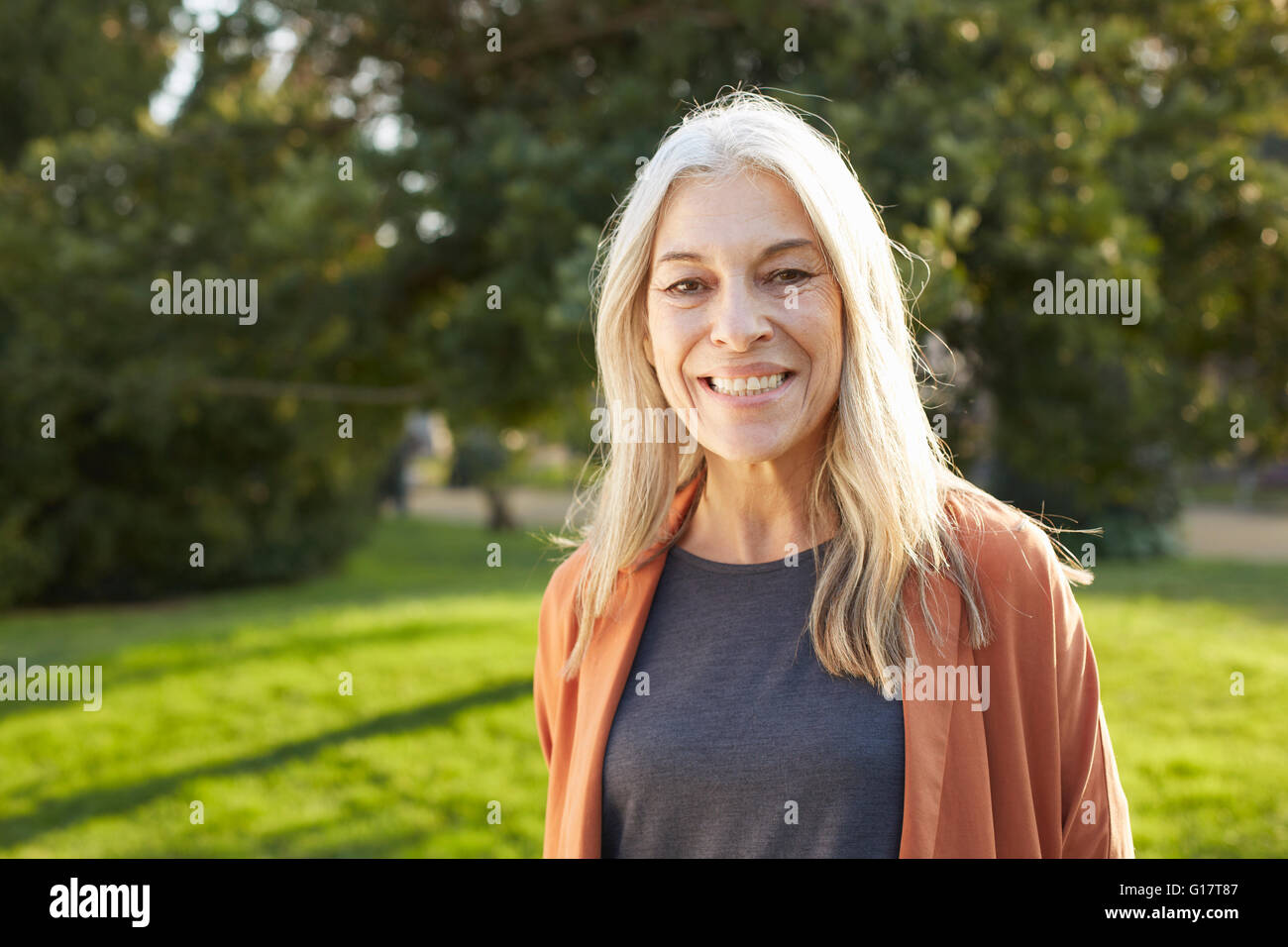 Portrait of grey haired senior woman looking at camera smiling Stock Photo