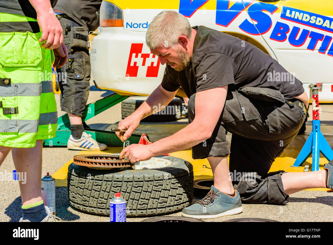 Emmaboda, Sweden - May 7, 2016: 41st South Swedish Rally in service depot. Crew working on removed brake disc in depot at team C Stock Photo