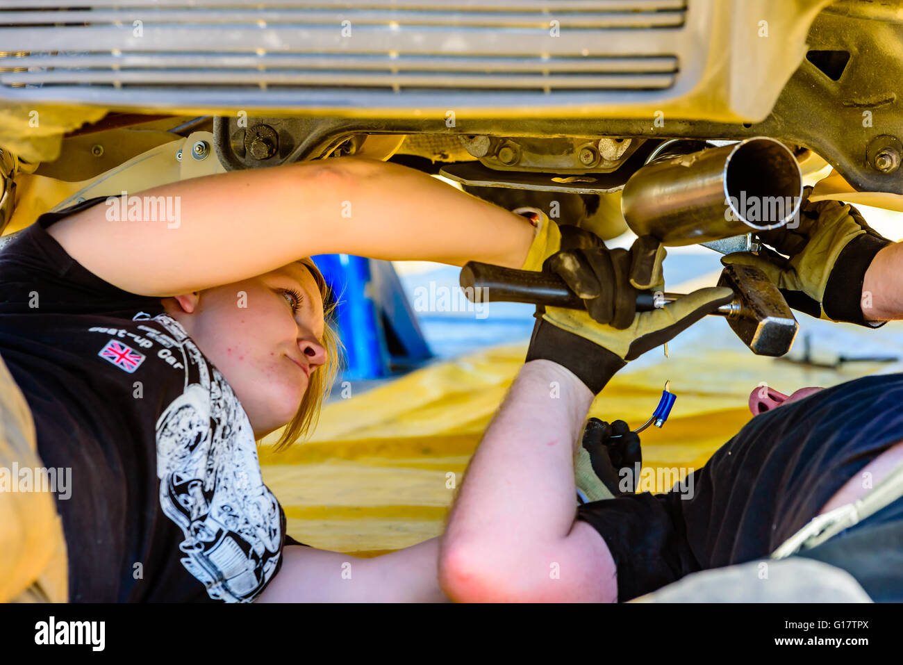 Emmaboda, Sweden - May 7, 2016: 41st South Swedish Rally in service depot. Crew working under the Mitsubishi EVO X at team Rydho Stock Photo