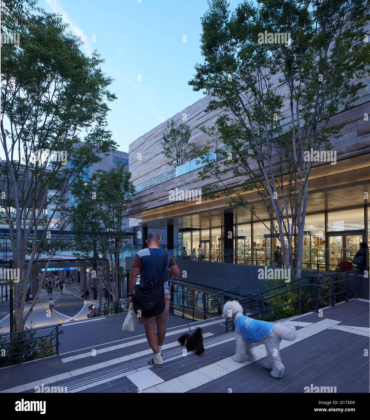 Overall view showing'street' with man and weird poodle. Futako-Tamagawa Development, Tokyo, Japan. Architect: Conran & Partners, 2015. Stock Photo