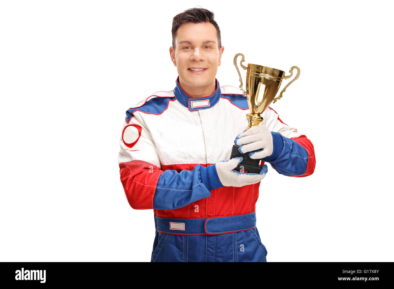 Young car racing champion holding a gold trophy and looking at the camera isolated on white background Stock Photo