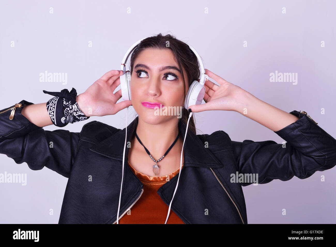 Music. Young hispanic woman listening to music with headphones. Playful ...