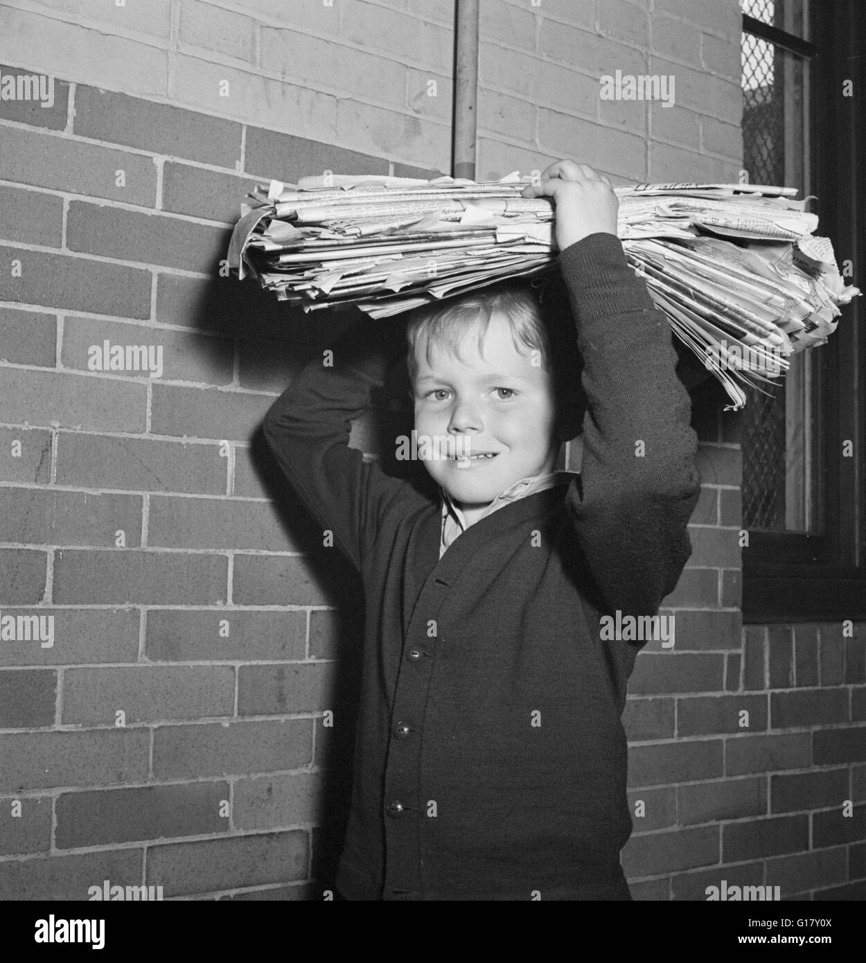 Boy Bringing Load of Scrap Paper to School during Scrap Salvage Campaign, Victory Program, Washington DC, USA, Marjorie Collins for Office of War Information, May 1942 Stock Photo