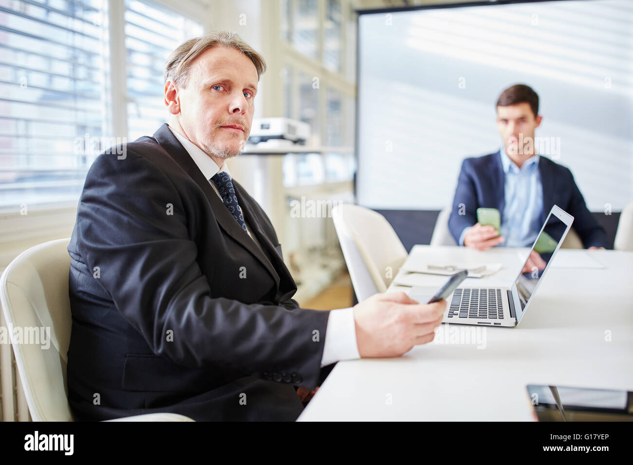 Business consulting man in business meeting with smartphone and computer Stock Photo