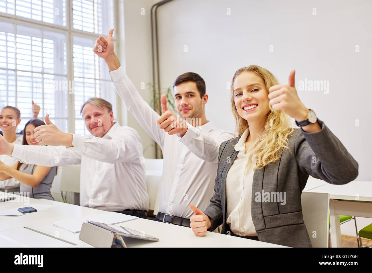 Successful business team cheering with thumbs up their success Stock ...