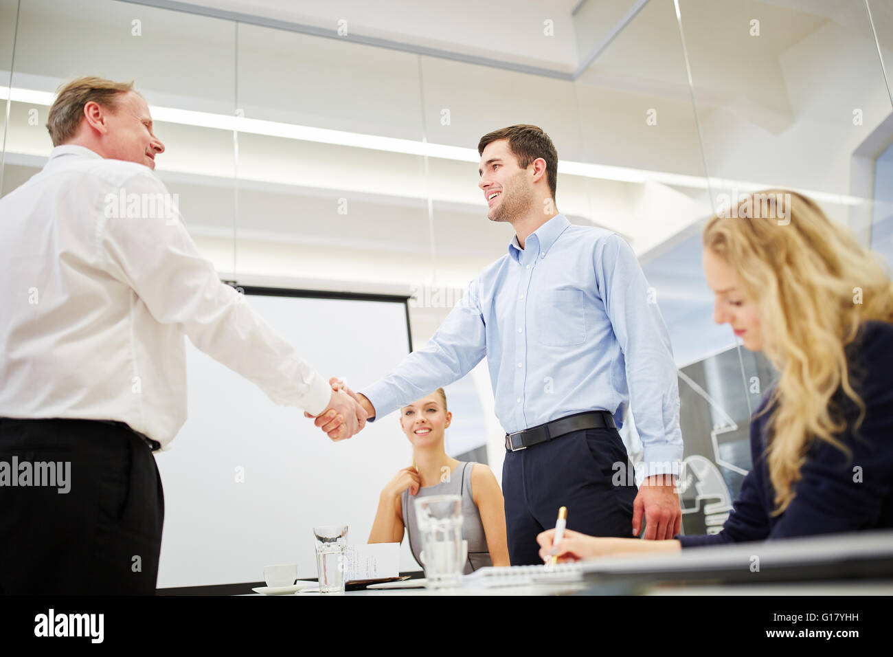 Congratulation with a hand shake between successful business people Stock Photo