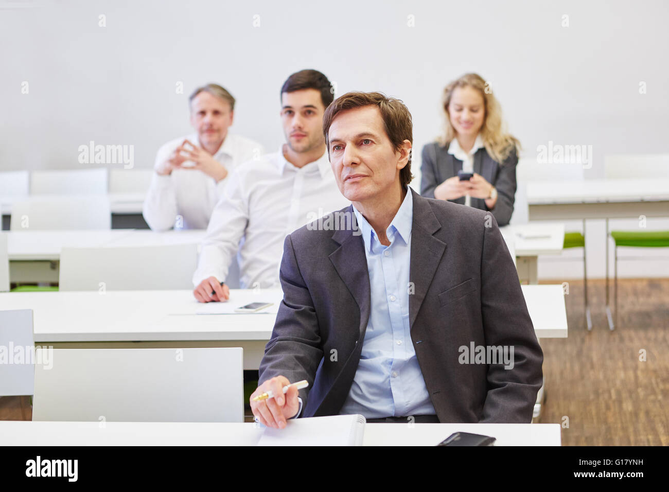 Business people in a business seminar listening to a spreech Stock Photo