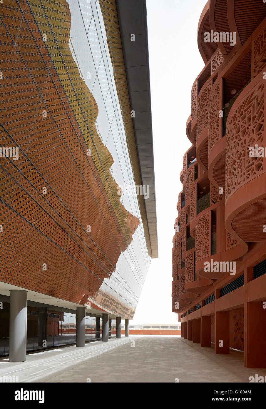 Perspective of terracotta and ceramic fritted glass facade. Masdar City, Masdar City, United Arab Emirates. Architect: various, Stock Photo