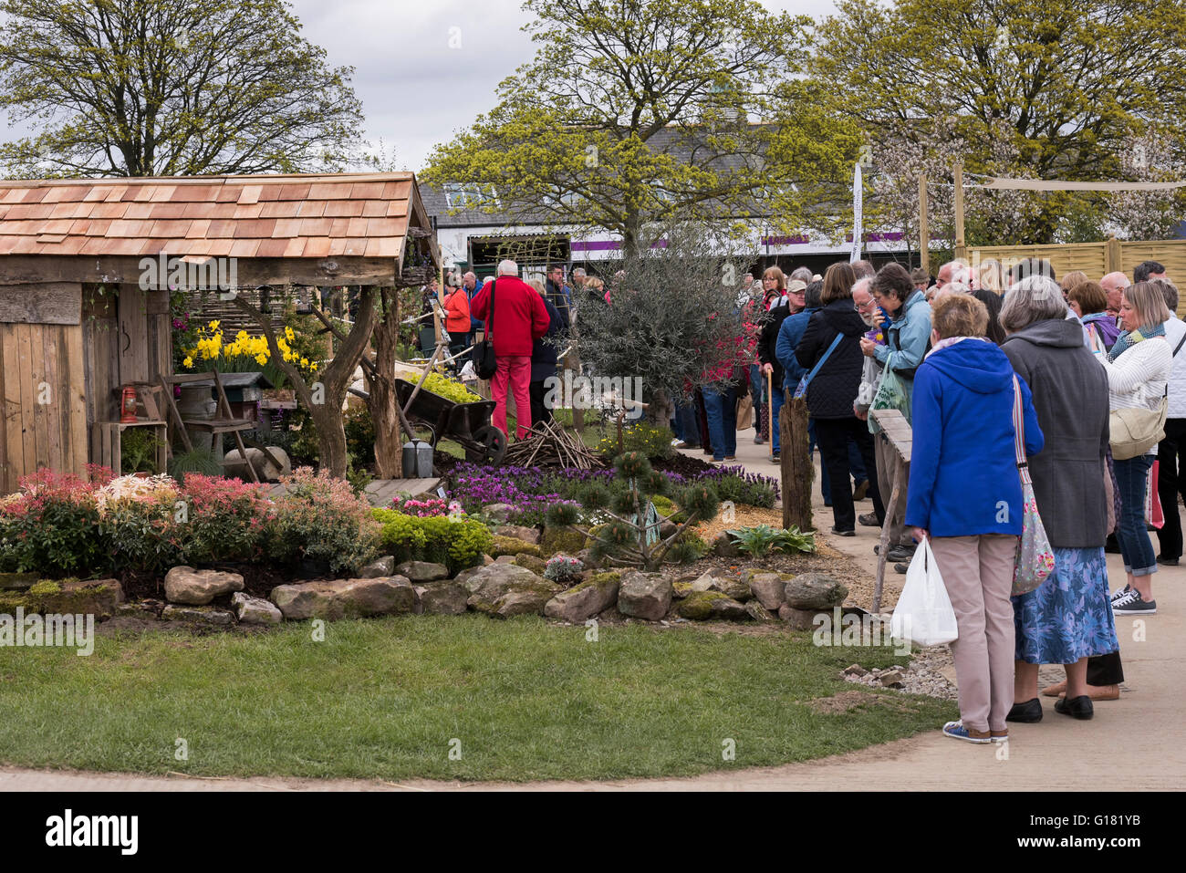 Visitors to the Harrogate Spring Flower Show 2016 (North Yorkshire, England) admire a natural show garden, 'Wildlife Paradise.' Stock Photo
