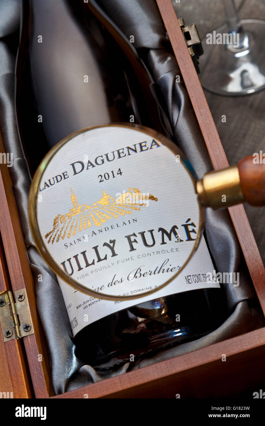 Magnifying glass on 2014 Jean-Claude Dagueneau Pouilly Fume wine bottle & label in presentation box Loire France Stock Photo