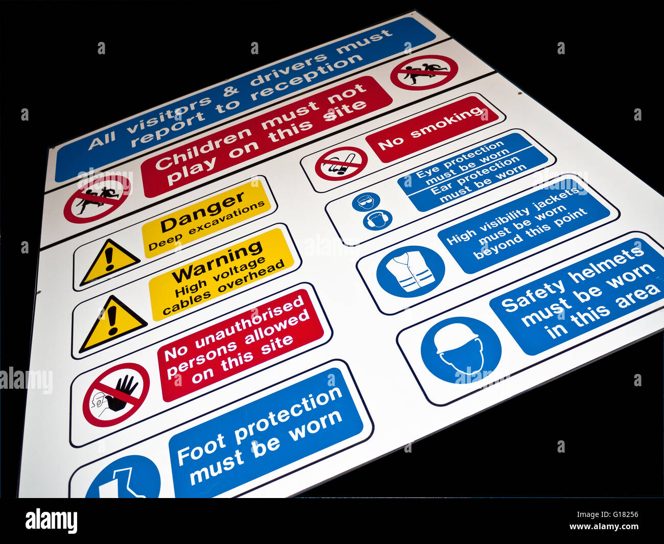 Health and safety hazard danger caution mandatory warning signs and rules outside entrance to UK construction building site Stock Photo