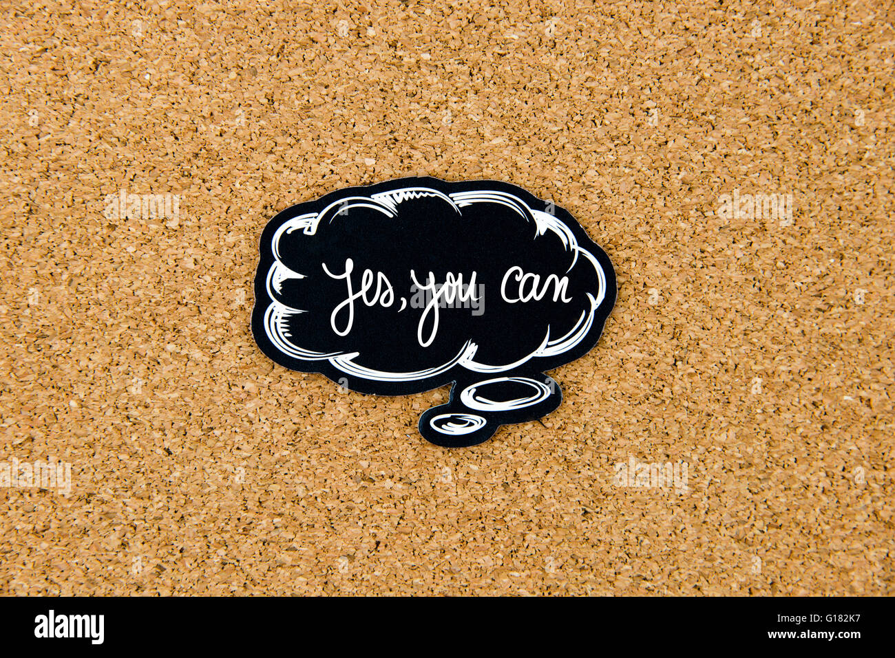 YES, YOU CAN written on black thinking bubble over cork board background, copy space available Stock Photo