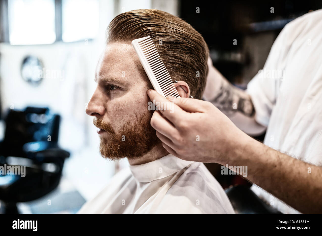 Combing of hair and styling in barber shop Stock Photo