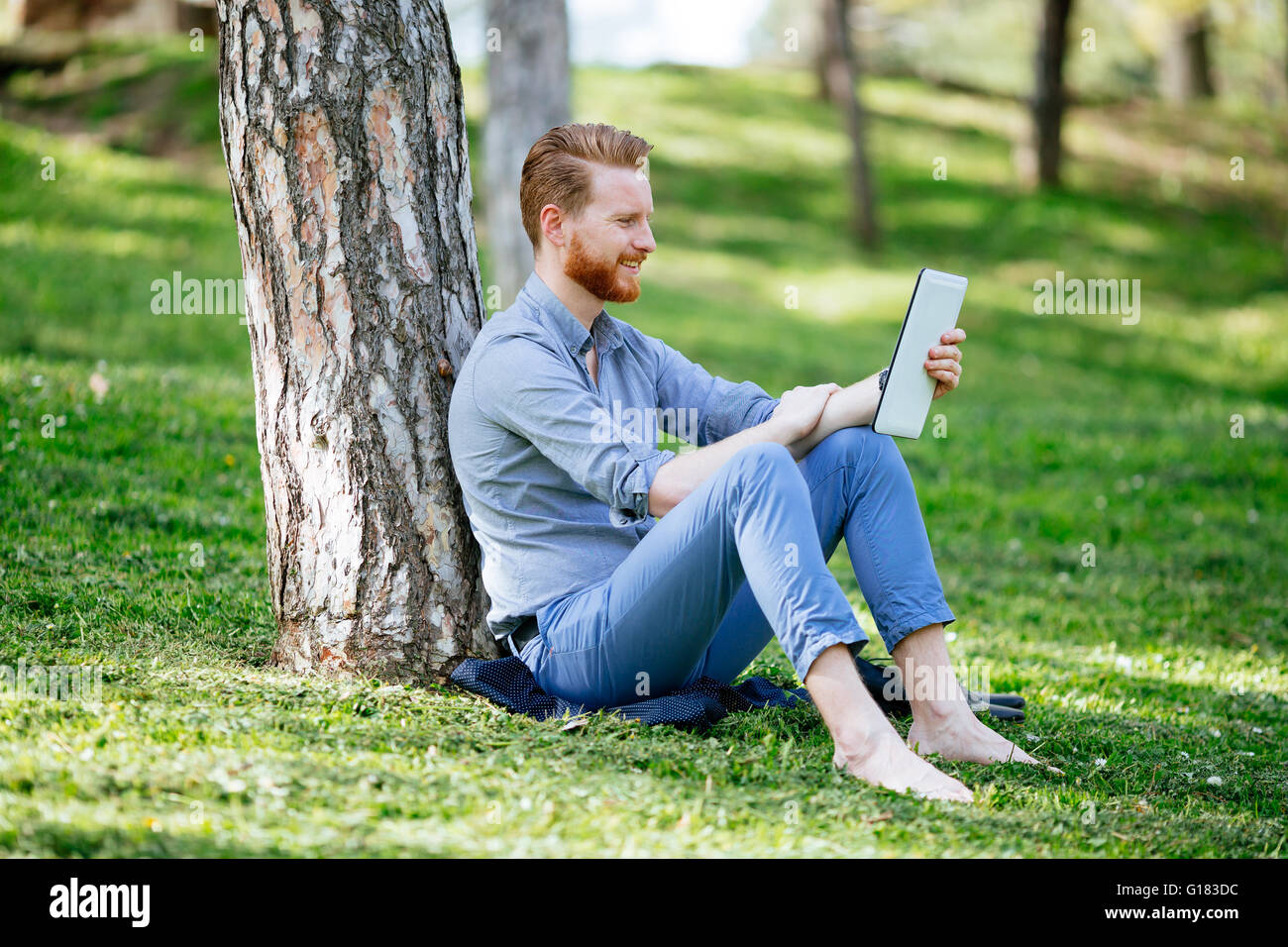 Student studying outdoors in park Stock Photo - Alamy