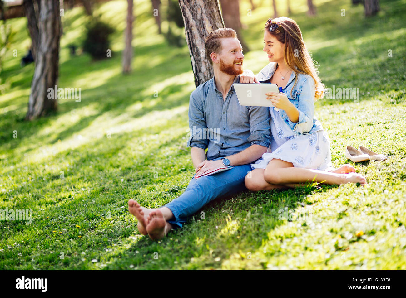 Lovely university students studying outdoors in park Stock Photo - Alamy