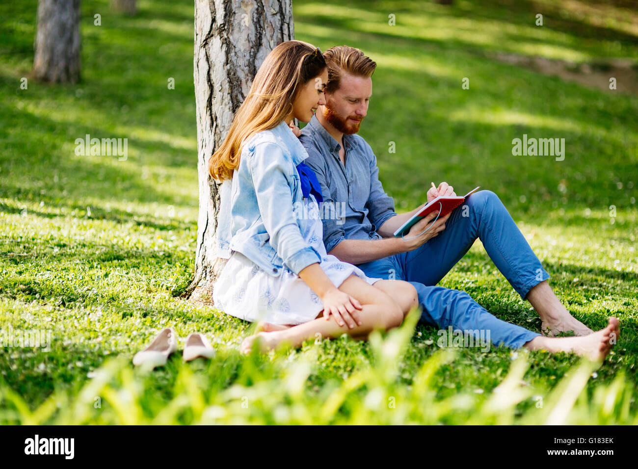 Lovely university students studying outdoors in park Stock Photo - Alamy