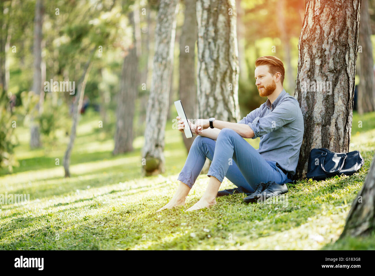Student studying outdoors in park Stock Photo - Alamy