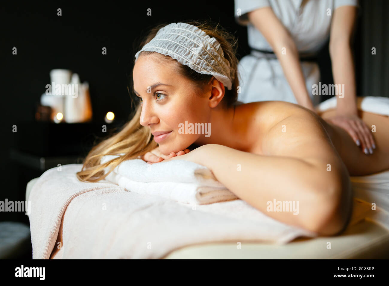 Lovely brunette enjoying massage treatment by therapist Stock Photo