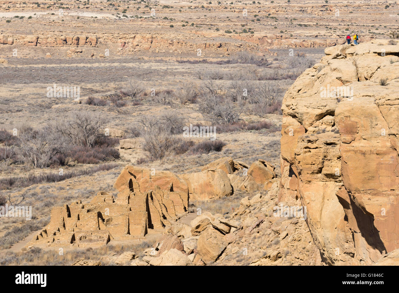 Hikers overlooking Kin Kletso ruins, Chaco Culture National Historical ...