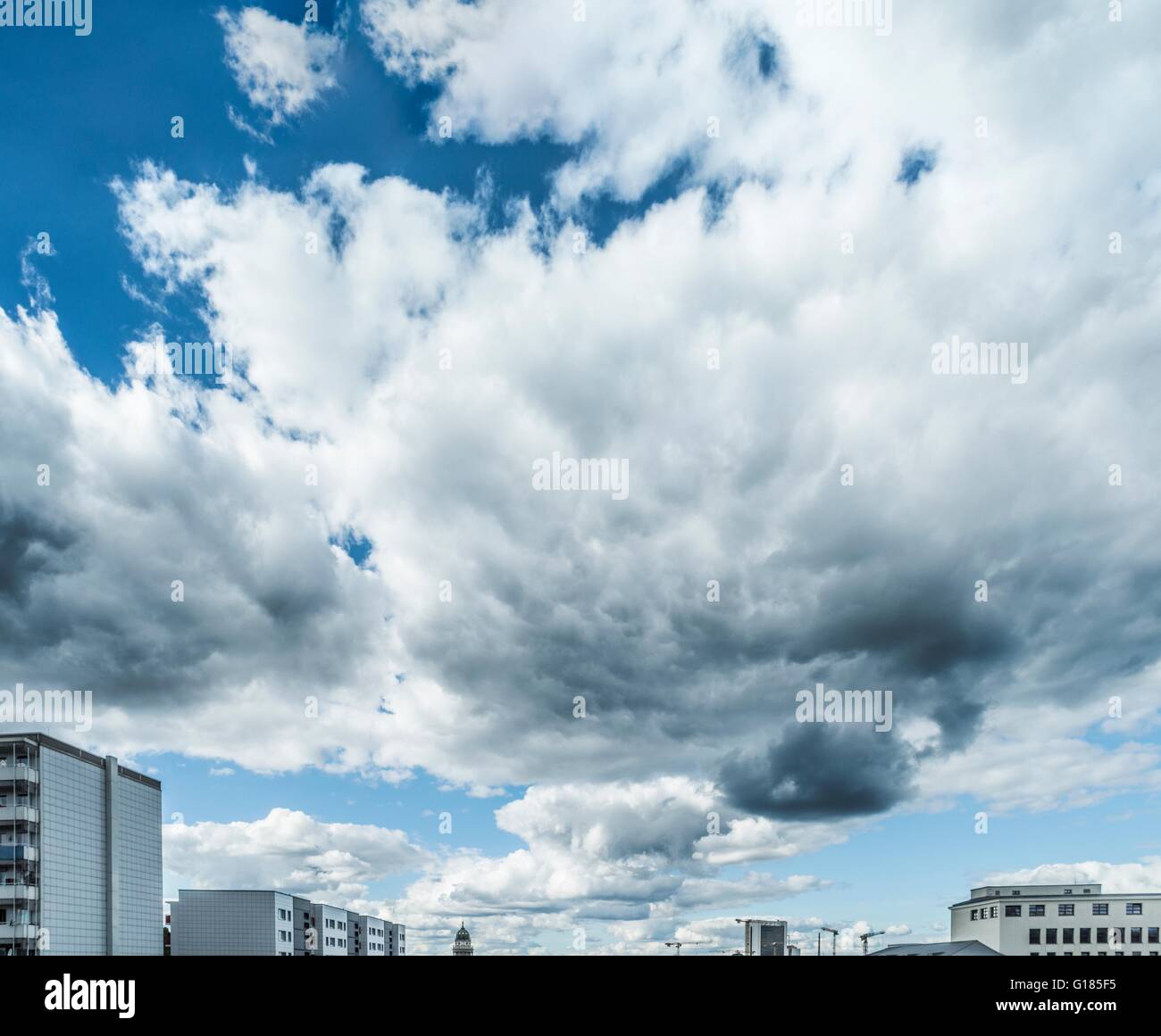Cloudscape over city skyline Stock Photo