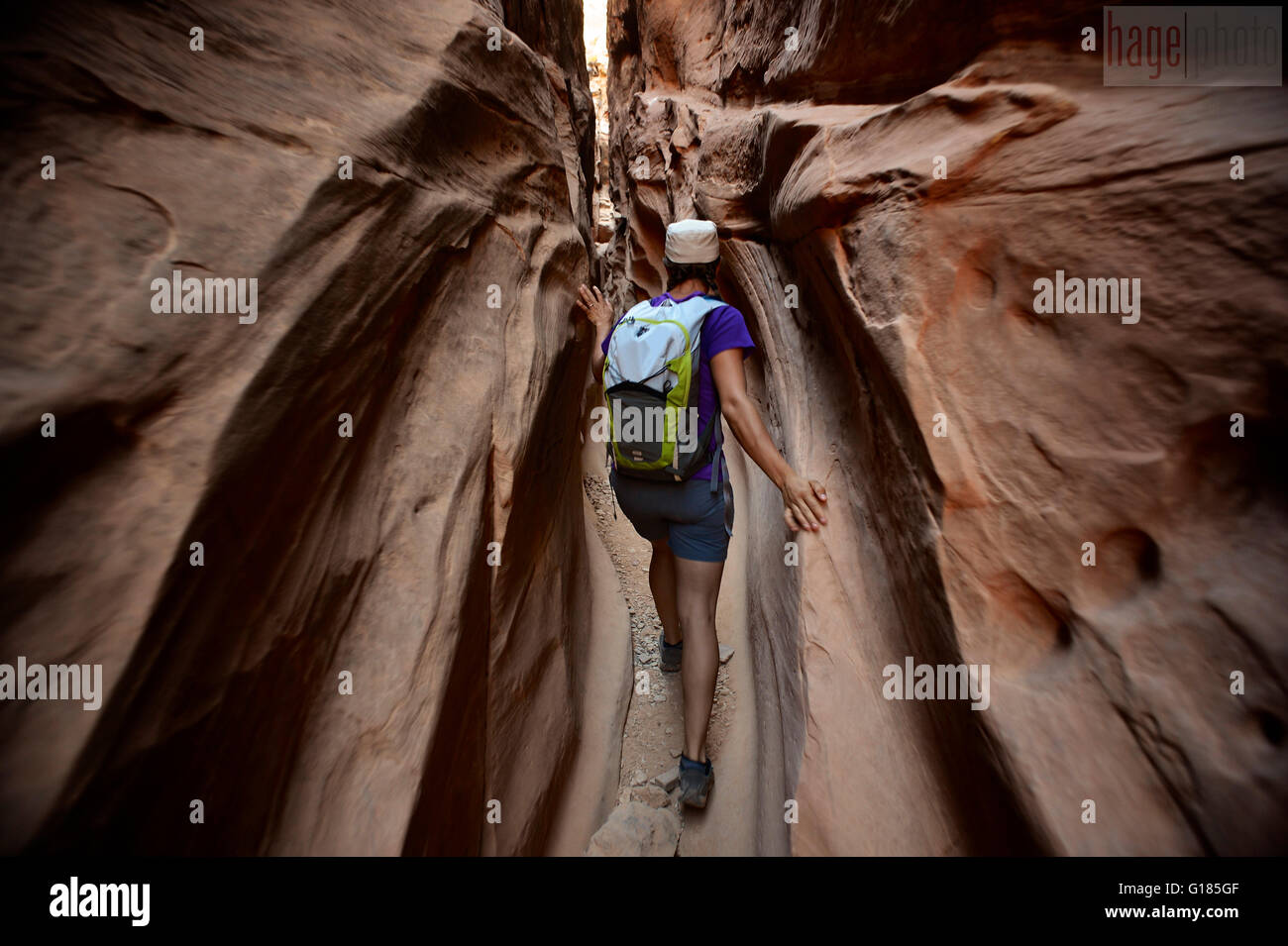 Hiker exploring Little Wild Horse and Bell Canyon Loop, Goblin Valley State Park, San Rafael Swell, Utah Stock Photo