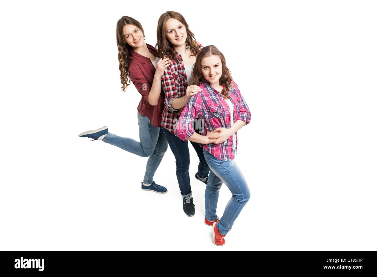 three healthy people exercising on white background Stock Photo