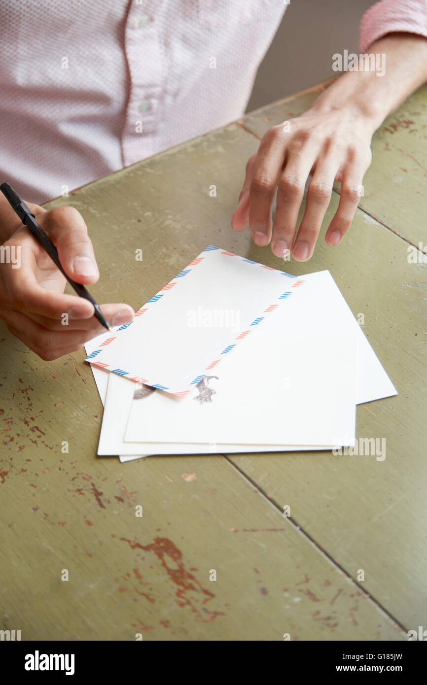 High angle view of young mans hands writing air mail letter Stock Photo