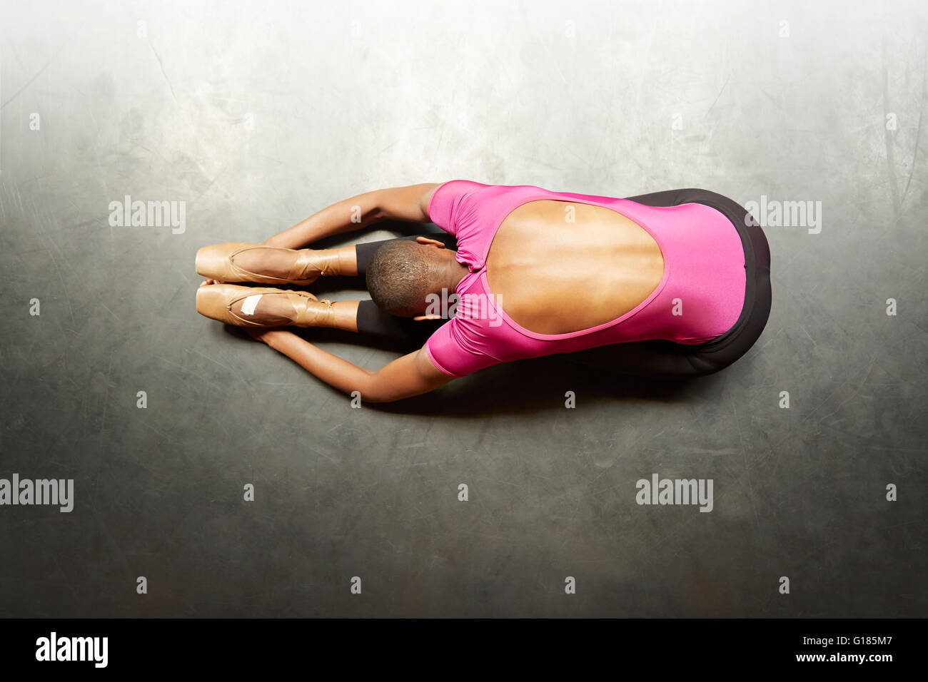 Ballet dancer doing stretching exercise Stock Photo