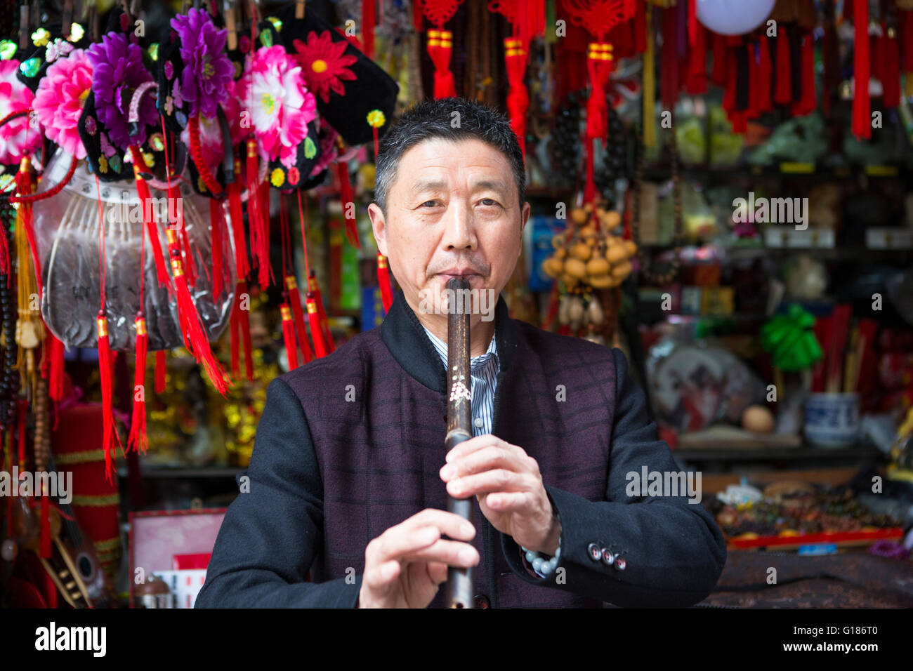 Portrait of a male Chinese flute player entrepreneur musician at an outdoor music shop in Nanjing Stock Photo