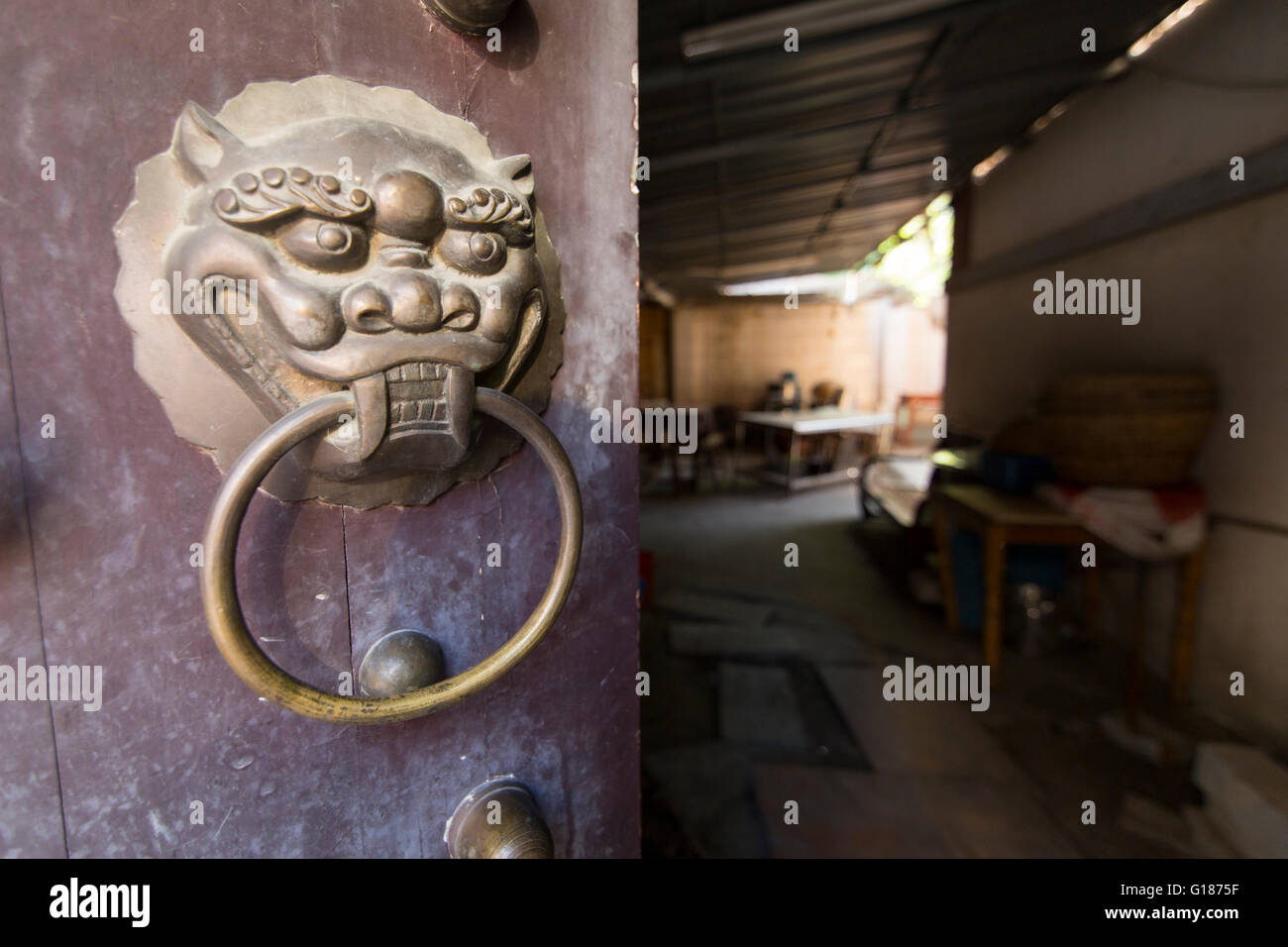 Old doorknob and a doorway in China Stock Photo
