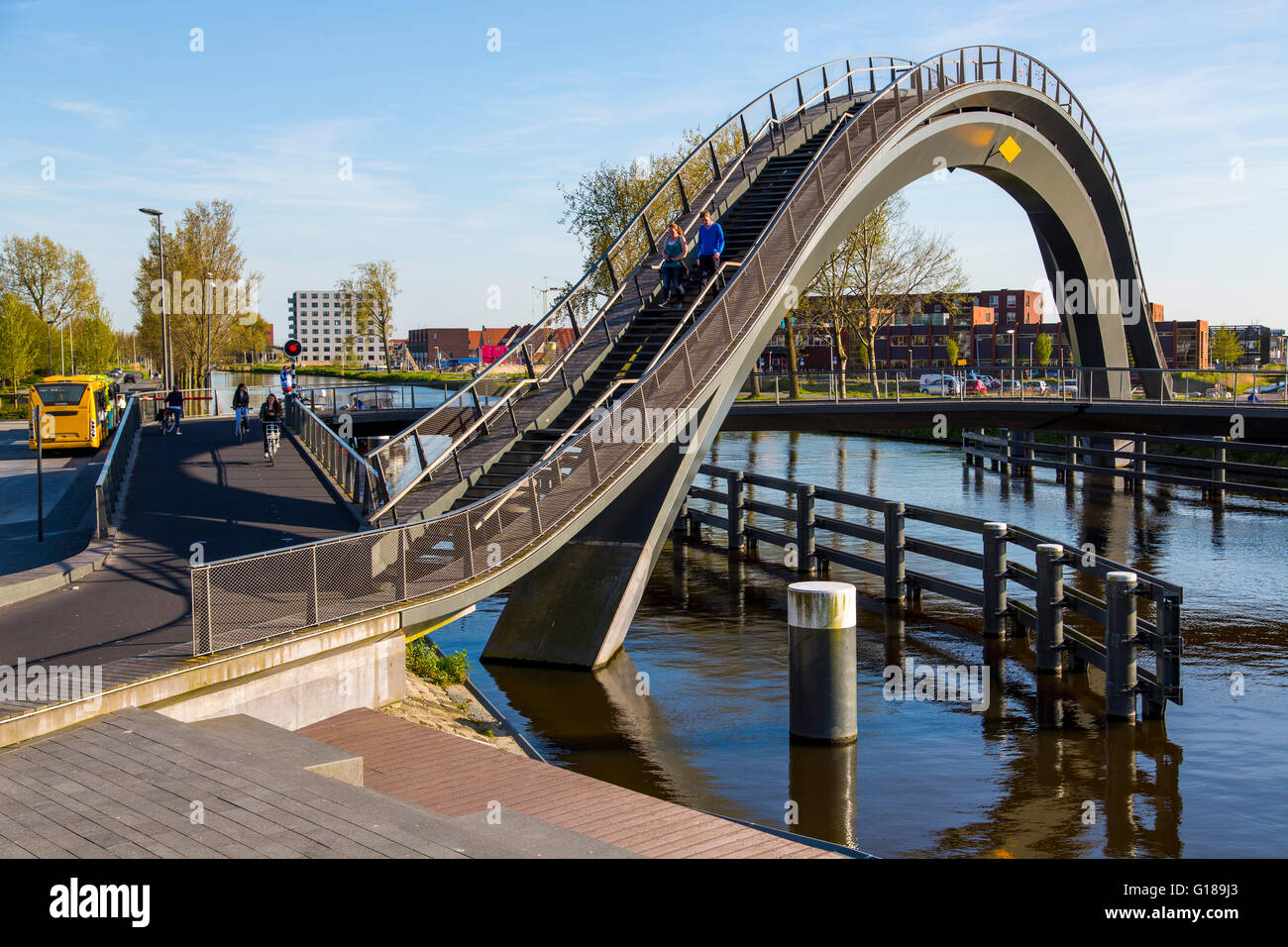 Cycle and pedestrian bridge, Melkwegbruk in Purmerend, North Holland, via a channel, arch bridge for pedestrians and cyclists Stock Photo