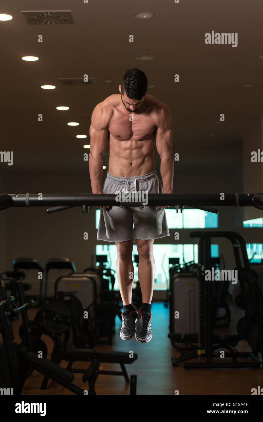 Young Bodybuilder Doing Dips on Bar Exercising Triceps On Machine In ...